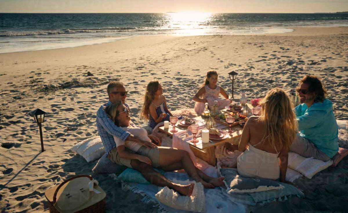 Family sitting eating near the ocean with Panama Beach Rentals